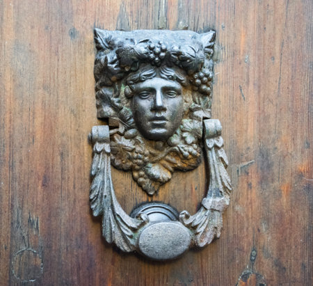 Details of an old wooden door in Florence, Tuscany, Italy.