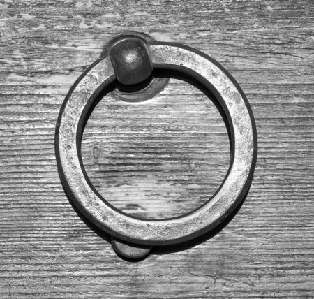 Details of an old wooden door in Florence, Tuscany, Italy (black and white)
