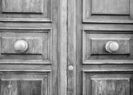 Details of an old wooden door in Florence, Tuscany, Italy (black and white).