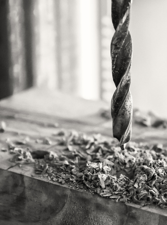 Joinery- drill press on wood close up. (Antique effect, sepia).の写真素材