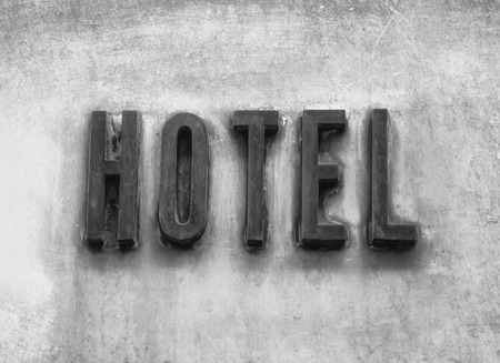 Hotel Sign On Wall Background. Vacation Concept, black and white.の写真素材