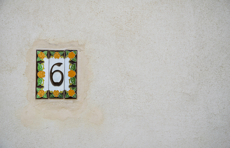 Traditional Italian home sign board painted on ceramic tile Placed on the wall. Number Six (6). Copy space for text.の写真素材