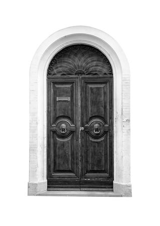 Wooden door in an old Italian house, isolated on white background, clipping path. Black and white.の写真素材