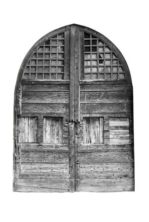 Wooden door in an old Italian house, isolated on white background, clipping path. Black and white.の写真素材