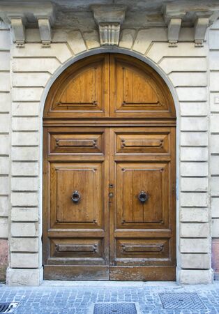 Wooden door in an old Italian house.の写真素材