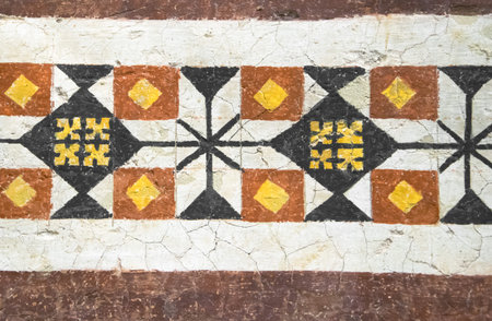 Rare and ancient colored decorations painted on wall in Italy.