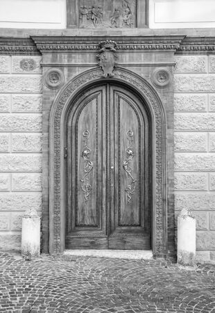 Wooden door in an old Italian house, black and white.の写真素材