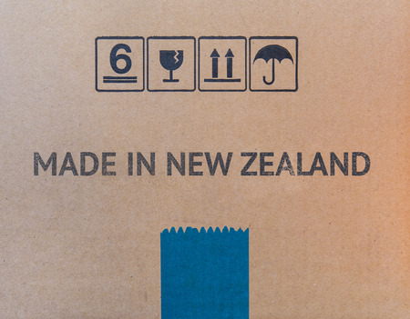 MADE NEW ZEALAND written on brown cardboard box.の写真素材