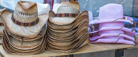 Rack of straw cowboy hats on sale.の写真素材