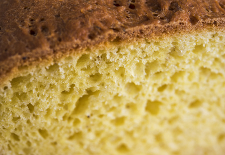 Home-made butter cake sliced ??on a wooden board. Natural light.の写真素材