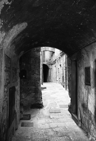 Alley of the city of Volterra in Italy, black and white