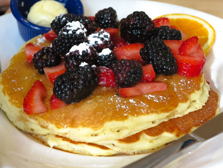 Chicago - Breakfast pancakes with blackberries, stroberries, orange and butter
