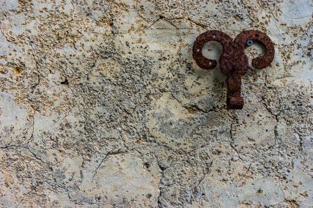 Rusty metal piece on old cracked wallの写真素材