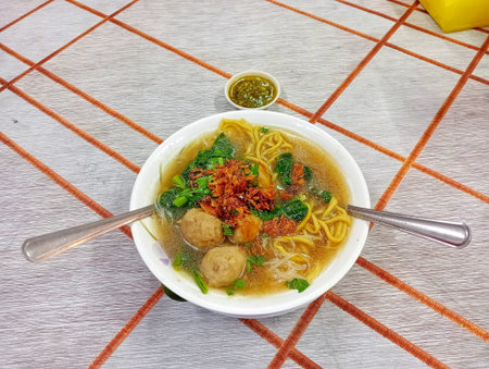 Vietnamese noodle soup with pork ball and spicy chili sauce