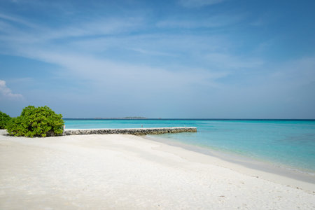 white sand beach and turquoise water on an island of Maldives