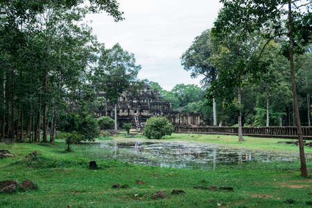 A beautiful photograph of one of the courtyards of the ruins of Ankgor Thom in Cambodia surrounded by a beautiful green forest - World Heritage Site by Unesco in 1992.の写真素材