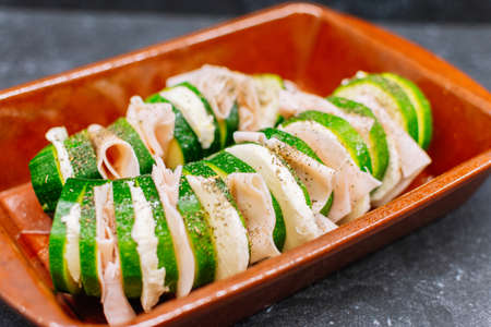 zucchini with turkey ham and black pepper on the top ready to bakeの写真素材