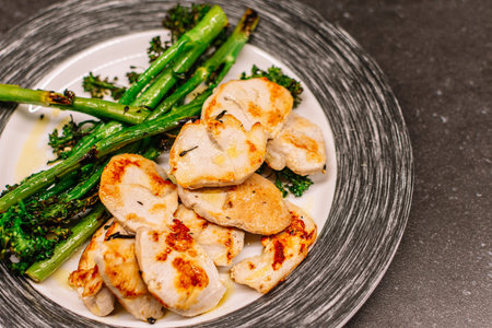Cooked broccolini with turkey fillet on a plate, top view. Healthy food conceptの写真素材
