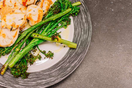 Cooked broccolini with turkey fillet on a plate. Copy spaceの写真素材