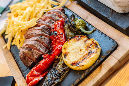 grilled vegetables and meat. Potatoes, peppers, barbecue steak. food close-up.の写真素材