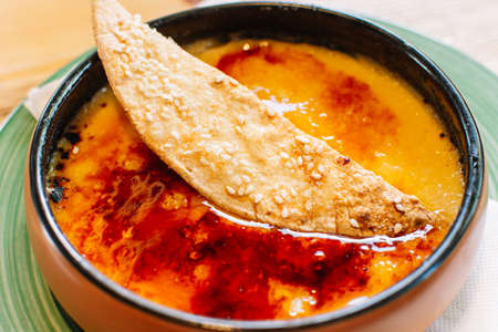 Traditional Catalan cream brulee on ceramic plate. Typical spanish dessert.の写真素材