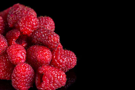 Fresh raspberries close up on a black background. Selective focusの写真素材