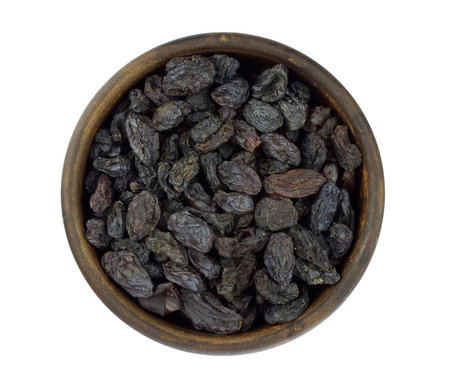 Raisins in bowl isolated over white backgroundの写真素材