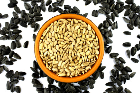 Close up sunflower seed in dish isolated on whiteの写真素材