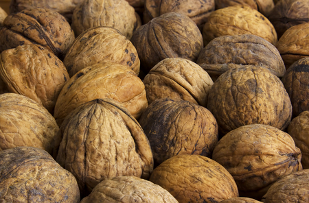 Walnuts background. Walnuts texture. Group walnuts on wooden background. Healthy organic food concept. Top view. View aboveの写真素材