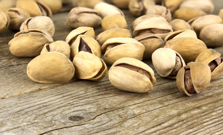 Roasted pistachios on natural wooden table backgroundの写真素材