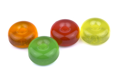 Pile of colorful fruit hard sugar candies, boiled sweeties or sugar plums isolated on white background cutoutの写真素材