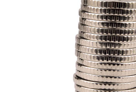 Silver towers made out of gold coins isolated on white