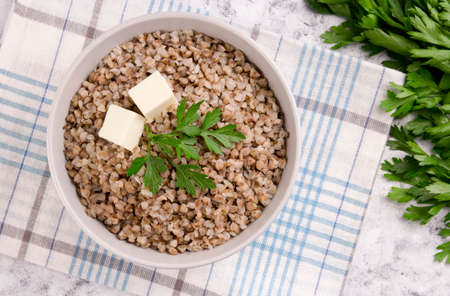 Freshly cooked buckwheat porridge in a plate on a gray background. Healthy food. Vegetarian food.の写真素材