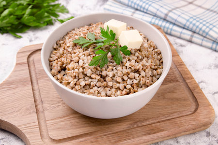 Freshly cooked buckwheat porridge in a plate on a gray background. Healthy food. Vegetarian food.の写真素材