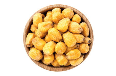 Roasted salted corn nuts in wooden bowl, isolated on white background. Beer snack, dry corn with...