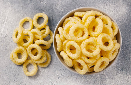 Beer snacks. Corn rings of sticks with cheese and green onion flavor. Junk food.の写真素材