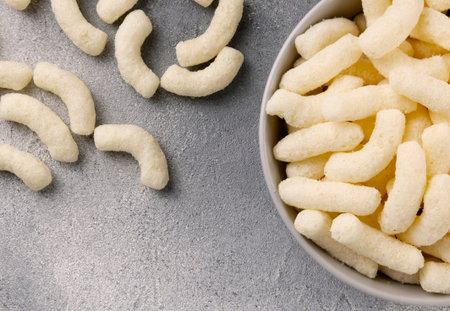 Air corn sticks in a ceramic plate on a gray background.の写真素材