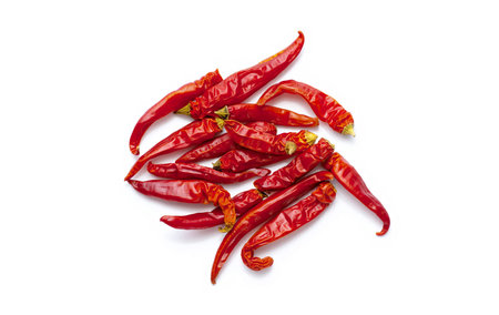 Dried red hot chili peppers, spices for seasoning food on white background