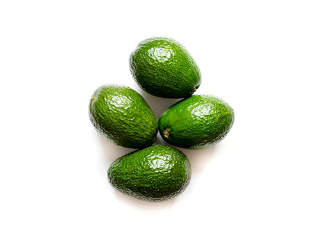 Fresh green avocados isolated on white background