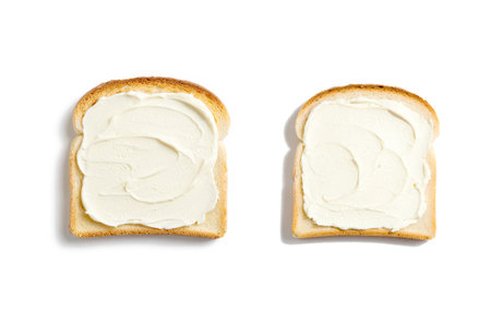 a slice of bread with fresh cream cheese on a white background