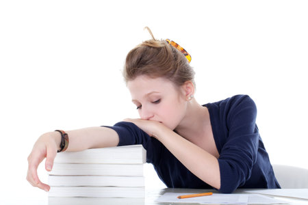 young female student sleeping above the books