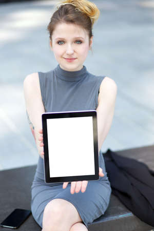 young businesswoman showing digital tabletの写真素材