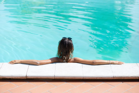 young woman relaxing at swimming pool