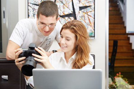 Participants of a photo workshop looking at camera display