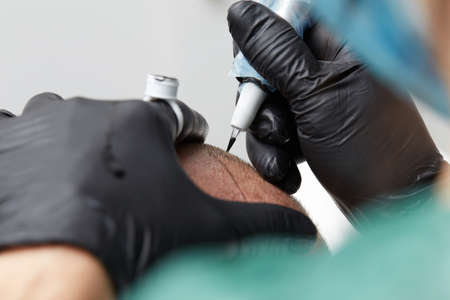 professional tattooist making permanent make up tricopigmentationの写真素材