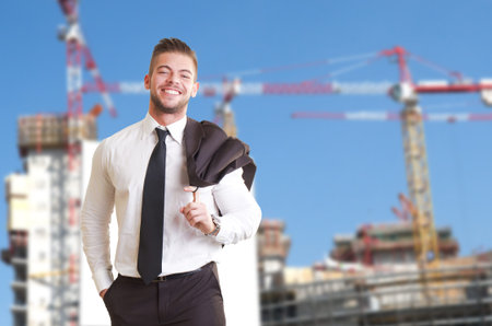 young architect standing front of construction site