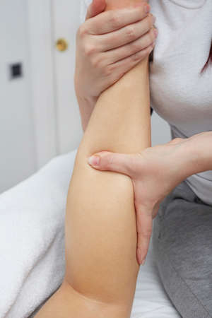 Beautiful woman having relaxing massage on her legsの写真素材
