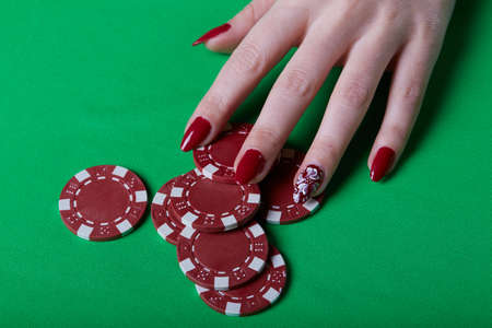 pretty young woman gambling on green tableの写真素材