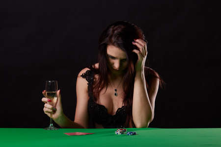 pretty young woman gambling on green tableの写真素材