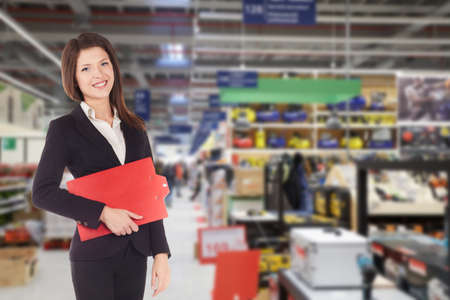 Young happy smiiling businesswoman doing apprenticeship in a supermarketの写真素材